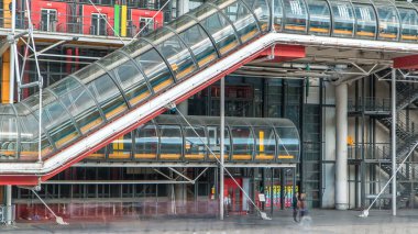 Tube with escalator going up of the Centre of Georges Pompidou timelapse in Paris, France. The Centre of Georges Pompidou is one of the most famous museums of the modern art in the world. clipart