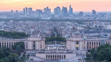 Aerial view over Trocadero day to night transition timelapse with the Palais de Chaillot seen from the Eiffel Tower in Paris, France. Top view from observation deck with modern skyscrapers and towers clipart