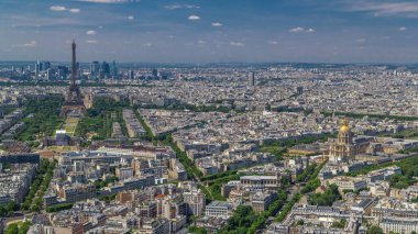 Aerial view from Montparnasse tower with Eiffel tower and skyscrapers of La Defense district on background timelapse in Paris, France. Top view from observation deck at sunny summer day. clipart