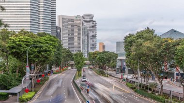 Traffic with cars on a street and urban scene in the central district of Singapore aerial timelapse. Nicoll highway with skyscrapers on a background clipart