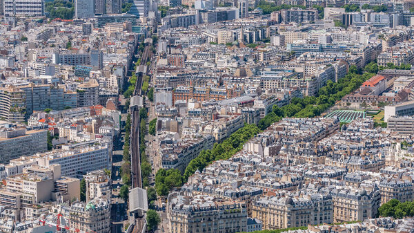 Top view of Paris skyline from above timelapse. European megapolis with Boulevard de Grenelle and metro line. Bird-eye view from observation deck of Montparnasse tower. Paris, France