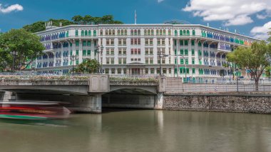 Old Hill Street Police Station historic building with bridge and river in Singapore timelapse. Neoclassical style building with colorful windows. Blue sky with clouds clipart