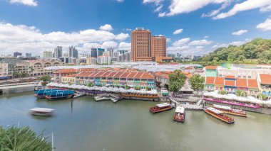 Tourist boats docking at Clarke Quay harbor aerial timelapse with colorful houses. Clarke Quay is a historical riverside quay in Singapore, located within the Singapore River Planning Area. clipart