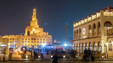 Souq Waqif night timelapse. It is popular marketplace in Doha, Qatar. The souq is noted for selling traditional garments, spices, handicrafts, and souvenirs. Islamic center on background clipart