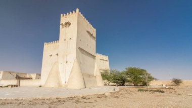 Barzan Towers timelapse hyperlapse, watchtowers in Umm Salal Mohammed near Doha - Qatar, the Middle East. Blue sky at sunny day clipart