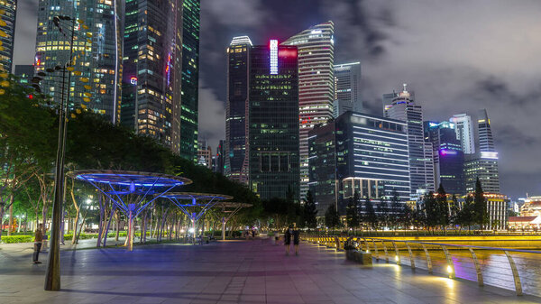 Business Financial Downtown City and Skyscrapers Tower Building at Marina Bay night timelapse hyperlapse from walking area, Singapore, Cityscape Urban Landmark and Business Finance District Center