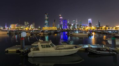 Yachts and boats at the Sharq Marina with modern skyscrapers night timelapse hyperlapse in Kuwait. Kuwait City, Middle East. clipart