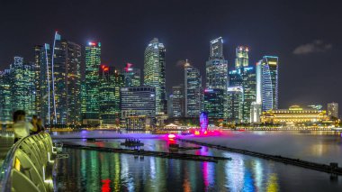 Light and Water Show along promenade in Marina Bay timelapse. The show of dancing fountains is one of biggest attractions in Singapore by night. Illuminated skyscrapers on background