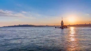 Maidens tower with beautiful sunset panoramic timelapse in Istanbul, turkey, kiz kulesi tower. City skyline on background with reflection on Bosforus water