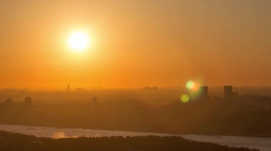 Colorful sunset on Bosphorus timelapse from asian part of the city on Camlica hill top with city skyline and 15th July Martyrs Bridge in Istanbul. Orange sky