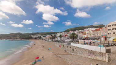 Panorama showing aerial view of Sesimbra Town and seaside timelapse, Portugal. Top landscape with houses and beach from fortress. Castle on the hill. Resort in Setubal district clipart