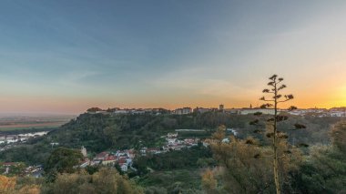 Panorama showing sunset over the Castle of Almourol on hill in Santarem aerial timelapse. A medieval castle atop the islet of Almourol in the middle of the Tagus River and houses. Portugal clipart