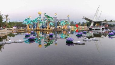 Dubai Glow Garden 'da çiçekli ve şatolu bir göl. Çevre dostu mimarinin yer aldığı, geri dönüşümlü ürünlerden çeşitli yapılar yaratan bir sanat devleti..