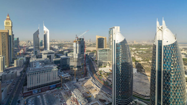 Skyline view of the buildings of Sheikh Zayed Road and DIFC timelapse in Dubai, UAE. Skyscrapers in financial centre aerial view from above before sunset