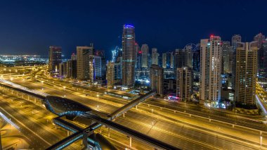 Dubai Yat Limanı gökdelenler hava üstten görünüm güneş doğmadan önce Jlt gelen Dubai gece gün timelapse, Birleşik Arap Emirlikleri için. Işıklı modern kuleleri ve Şeyh zayed yolu üzerinde trafik.