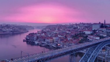 Day to night transition aerial panoramic view of the historic city of Porto, Portugal timelapse with the Dom Luiz bridge. Colorful sky after sunset