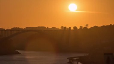 Sunset over old city Porto at river Duoro, with orange sky and the Arrabida bridge, Oporto, Portugal. Aerial view from above at evening