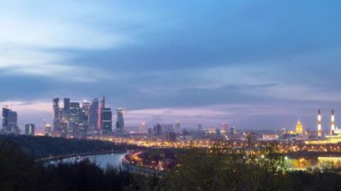 Panoramic view of Moscow City, Russia, from Sparrow Hills day to night transition timelapse from above. Cloudy colorful sky over skyscrapers