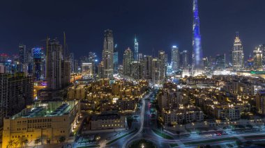 Dubai Şehir Merkezi 'nin ufuk çizgisi Burj Halife ve diğer panoramik manzaralı tüm gece boyunca Dubai, Birleşik Arap Emirlikleri. Gökyüzünde ay var. Geleneksel ve modern binalar.