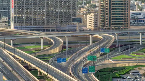 Aerial view of highway interchange in Dubai downtown timelapse. Cityscapes traffic bridge, logistics. Roads and lanes Crossroads, Dubai, United Arab Emirates
