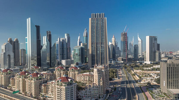 Skyline view of the buildings of Sheikh Zayed Road and DIFC timelapse in Dubai, UAE. Skyscrapers in financial centre aerial view from above in downtown