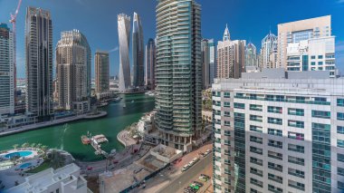 Dubai Marina konutlarının ve sahil manzaralı ofis gökdelenlerinin panoramik görüntüsü. Yüzen tekneler ve yatlar