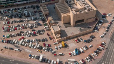 Hava manzaralı araçlar Dubai, BAE 'deki büyük açık hava otoparklarında. Ofis ve konut trafiği ve diğer arabalarla dolu otopark. Girip çıkmayı dene, park yeri bul..