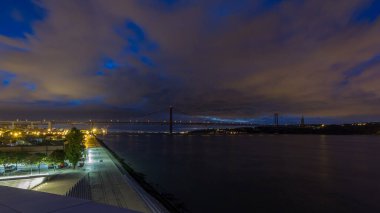 Lisbon city before sunrise with April 25 bridge night to day transition panoramic timelapse, Cristo Rei and waterfront early morning clipart