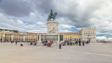 Bronze statue of King Jose I and triumphal arch at Rua Augusta at Commerce square timelapse hyperlapse in Lisbon, Portugal. Cloudy sky. Walking area