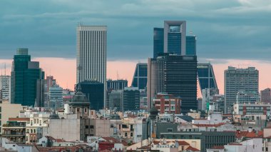 Madrid Skyline at sunset timelapse with some emblematic buildings and towers, part of the Cuatro Torres Business Area and also a side of Santiago Bernabeu Stadium. clipart