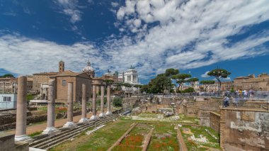 Ancient Roman Forum timelapse hyperlapse, UNESCO World Heritage Site. Rome, Italy. Cloudy sky, green trees and Vittoriano on background