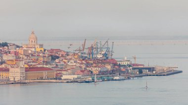 Lizbon tarihi merkezi Terreiro 'nun panorama do paco airial time apse Tagus veya Tejo Nehri' nin güney kıyısından izleniyor. Kırmızı çatılı binalar ve feribot terminalinde yüzen gemiler.