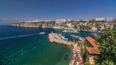 Aerial view of yacht harbor and red house roofs in Old town timelapse. Marine bay at touristic city center of Antalya. Sunny day in Antalya, Turkey landmark. Travel Antalya, Yachts of Antalya clipart