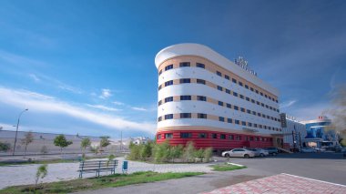Atyrau's Modern Residential Buildings Timelapse Hyperlapse. A Sunny Day Highlights Urban Growth Against a Blue Cloudy Sky in Kazakhstan clipart