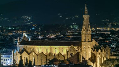 Basilica Santa Croce in Florence at night timelapse. Viewed from Piazzale Michelangelo viewpoint. Evening illumination. Aerial top view from above clipart