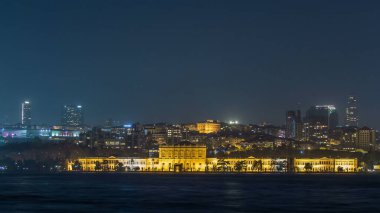 Illuminated Mimar Sinan University night timelapse. View to besiktas district in Istanbul taken from asian part of the city. Reflection on Bosphorus water