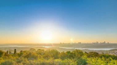 Colorful sunset on Bosphorus panoramic timelapse from asian part of the city on Camlica hill with city skyline and 15th July Martyrs Bridge in Istanbul.