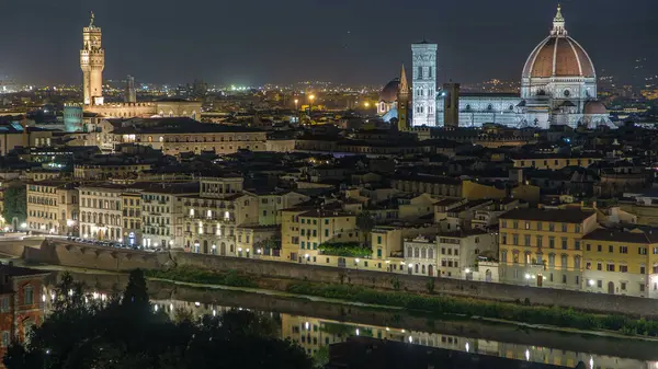 stock image Arnolfo tower of Palazzo Vecchio illuminated at night aerial timelapse and Basilica di Santa Maria del Fioreon on the Piazza della Signoria at twilight from Piazzale Michelangelo in Florence, Italy.