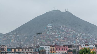 Slums on the slope of hill San Cristobal on the northern side of the river Rimac day to night timelapse. View from Muralla Park. Lima, Peru clipart