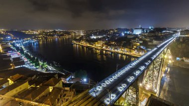 Night aerial view of the historic city of Porto, Portugal panoramic timelapse with the Dom Luiz bridge from above