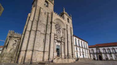 Porto Cathedral or Se Catedral do Porto timelapse hyperlapse front view with blue sky at sunny day. Romanesque and Gothic architecture.