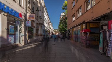Walk on Ferhadija pedestrian street crowded with people timelapse hyperlapse. Famous place in downtown with many shops and restaurants in Sarajevo clipart