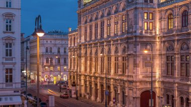Beautiful view of Wiener Staatsoper (Vienna State Opera) aerial day to night transition timelapse in Vienna, Austria. Illuminated historic buildings and traffic on streets clipart