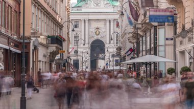Kohlmarkt street with Hofburg Complex timelapse in downtown of Vienna in Austria with crowd in the street. Many cafes and shops around clipart