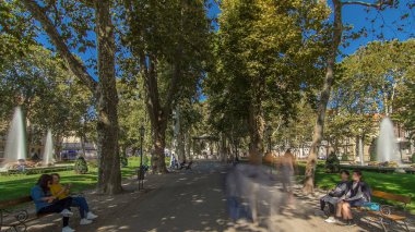 People walking around pavillion in Zrinjevac park timelapse hyperlapse in Zagreb, Croatia. Zrinjevac is spread over 12540 sq meters in city center. People relaxing on a bench