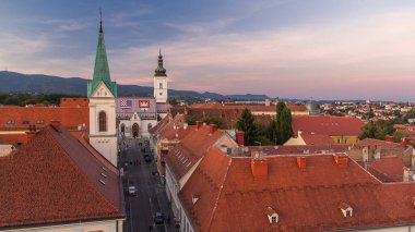 Church of St. Mark day to night transition timelapse and parliament building Zagreb, Croatia. Top view from Kula Lotrscak tower viewpoint after sunset