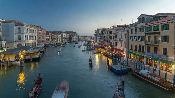 stock image Grand Canal in Venice, Italy day to night transition timelapse. Panoramic view on gondolas and city lights from Rialto Bridge. Beautiful and romantic Italian city on water.