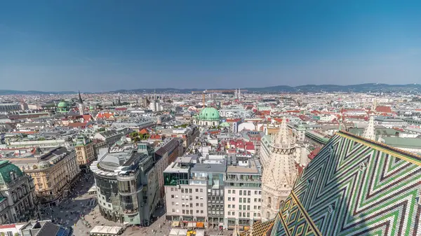 stock image Panoramic aerial view of Vienna, Austria, from south tower of st. stephen's cathedral timelapse. City skyline with historic buildings rooftops from above at sunny day