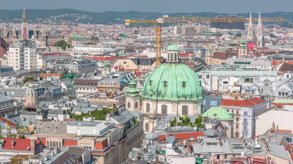 stock image Panoramic aerial view of Vienna, Austria, from south tower of St.. Stephen's cathedral timelapse. City skyline with historic buildings roofs and crane from above at sunny day