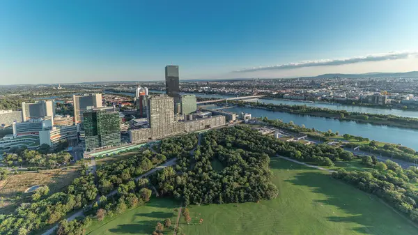 stock image Aerial panoramic view of Vienna city with Donau City skyscrapers, historic buildings and a riverside promenade timelapse in Austria. Evening skyline before sunset from Danube Tower viewpoint